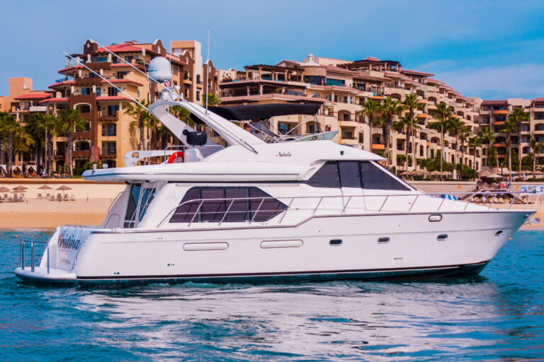 60' Bayliner flybridge motor yacht off the Cabo San Lucas beachfront