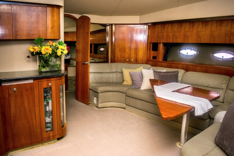 Wood-finished salon with dining area on the 52' Cruiser Express