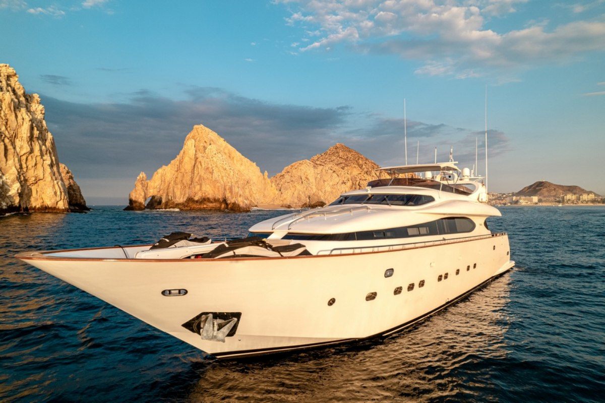 Luxury superyacht cruising past the Land's End rock formations in Cabo San Lucas